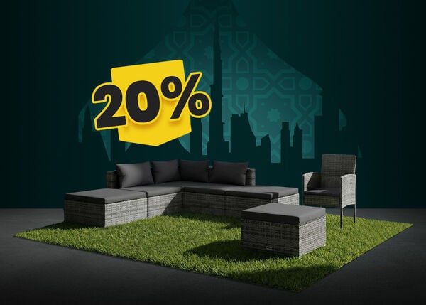 Grey rattan outdoor seating set with dark grey cushions, placed on grass with a city skyline backdrop, and a visible 20% discount tag.