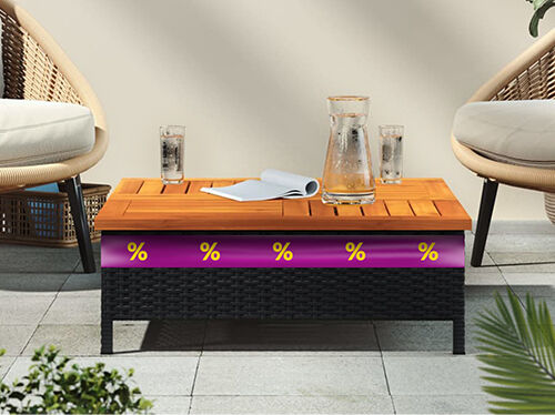 Black rattan and wooden slatted coffee table, placed between two chairs on an outdoor patio, with a purple promotional band featuring yellow discount icons. Click to see the products in the offer.