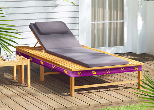 Wooden sun lounger with a grey cushion and a purple promotional band with yellow discount icons, on a wooden deck. 