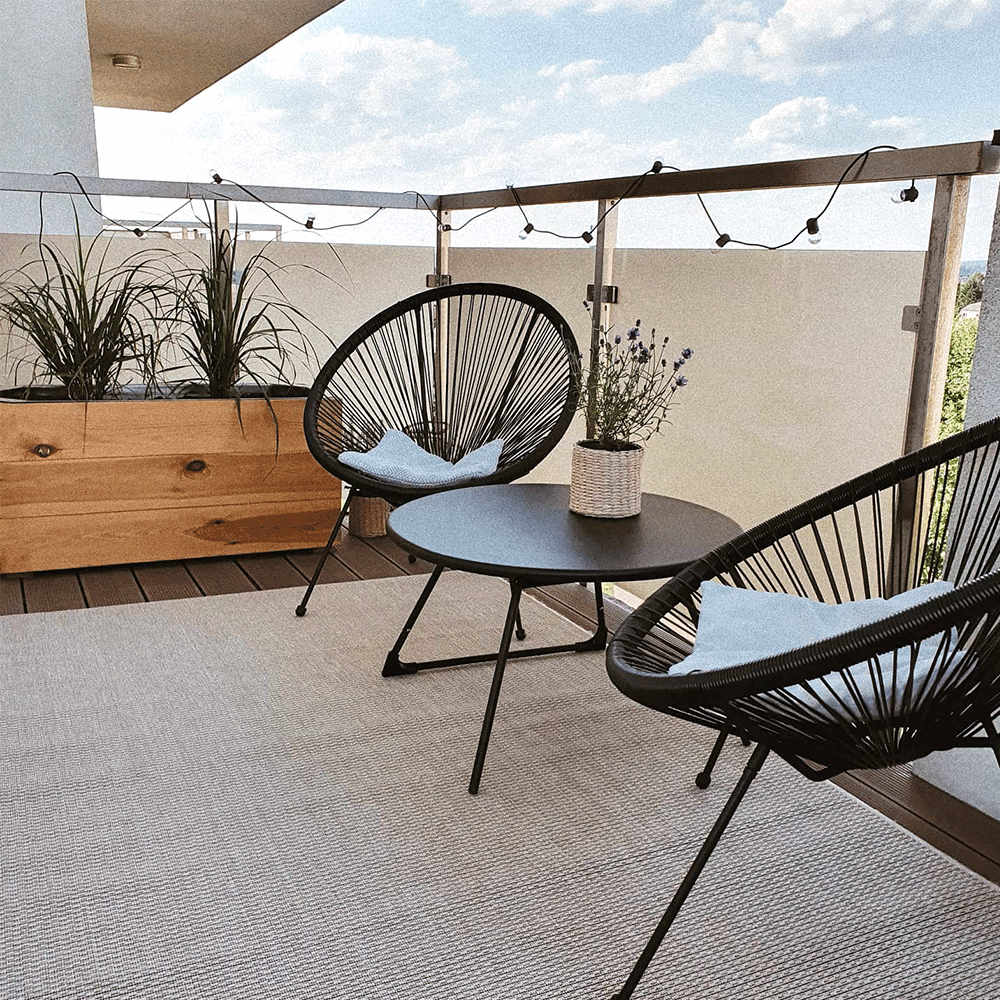 minimalistic setting on balcony, two chairs and a table