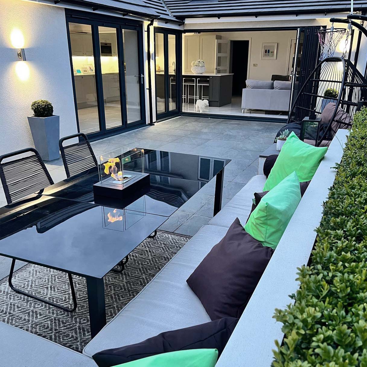 Renovated outdoor area with a glossy black vidaXL table