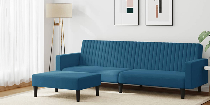Blue sofa and matching ottoman in a styled living room. Click to see the products in the collection.